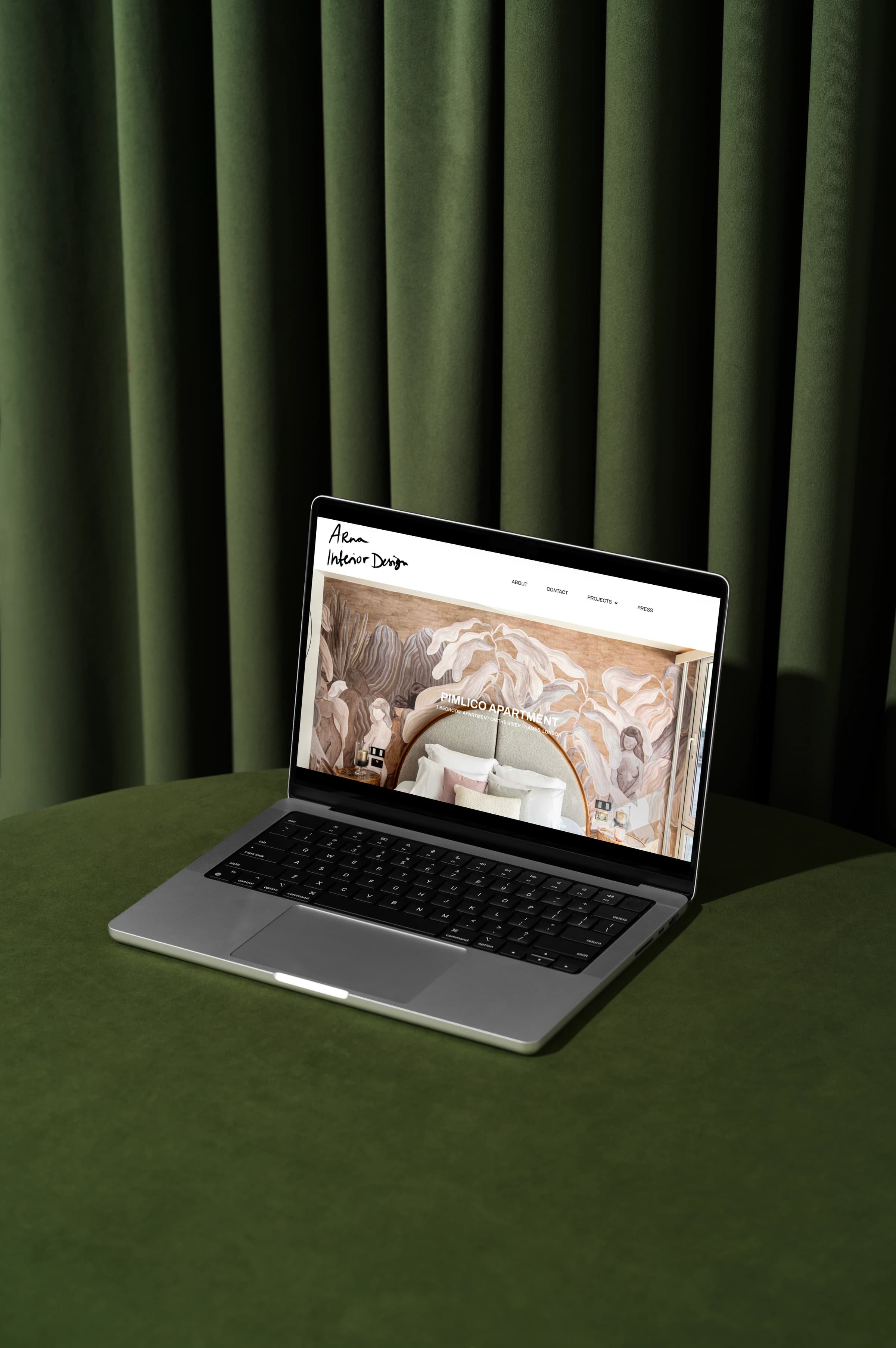 The Arna Interior Design website open on a laptop