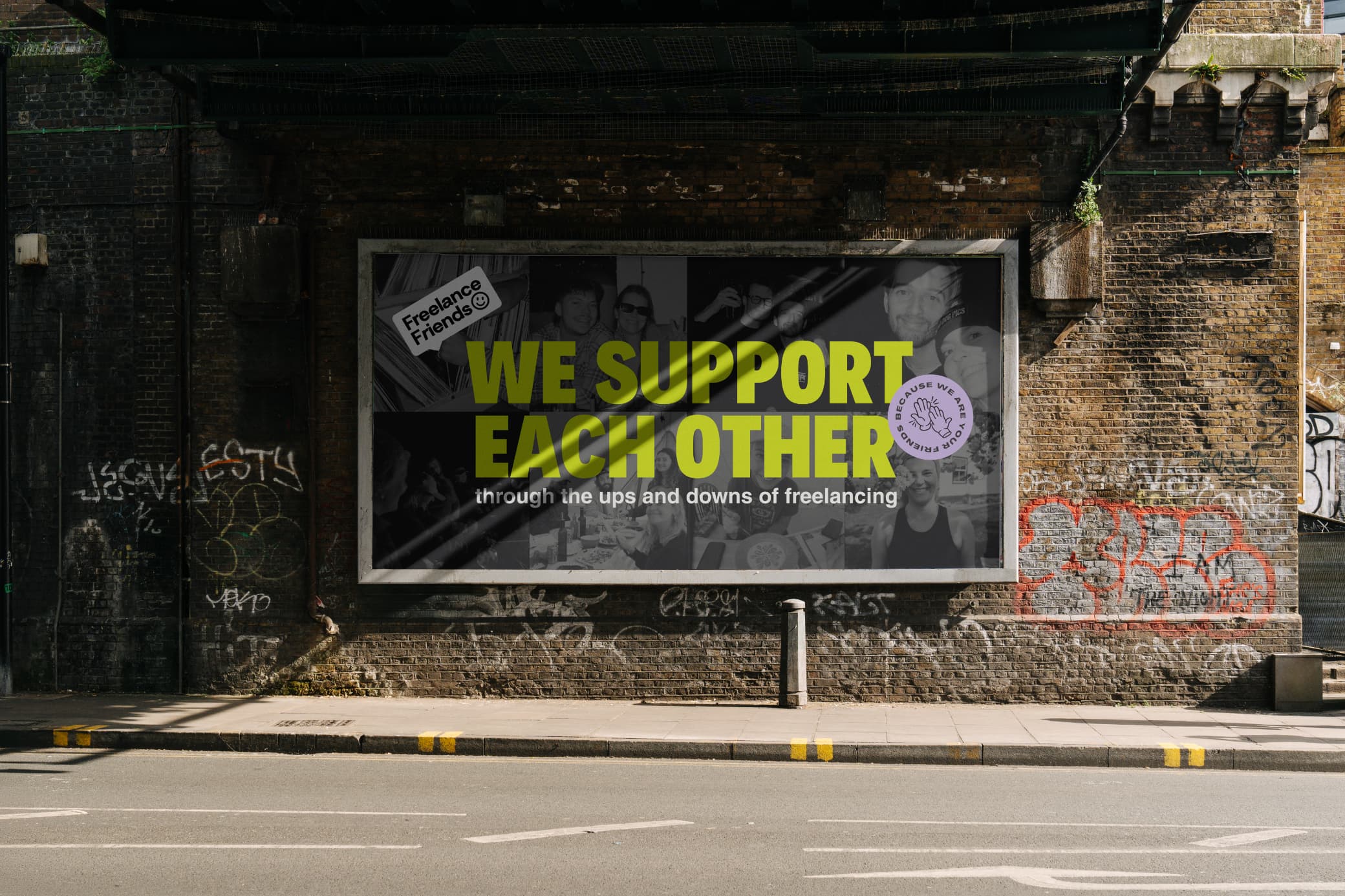 A Freelance Friends billboard under a railway arch in Hackney