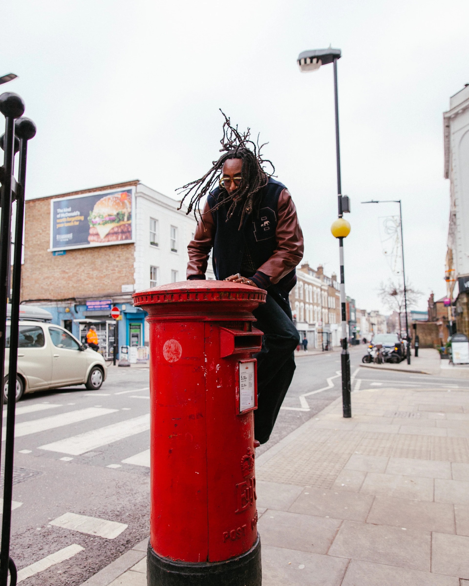 Seye Adelekan photographed on a post box in East London